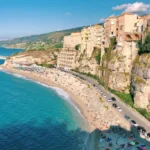 https://unsplash.com/photos/an-aerial-view-of-a-beach-with-a-cliff-in-the-background-Emjmmy2_uuo