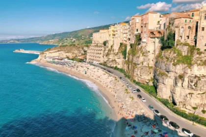 https://unsplash.com/photos/an-aerial-view-of-a-beach-with-a-cliff-in-the-background-Emjmmy2_uuo