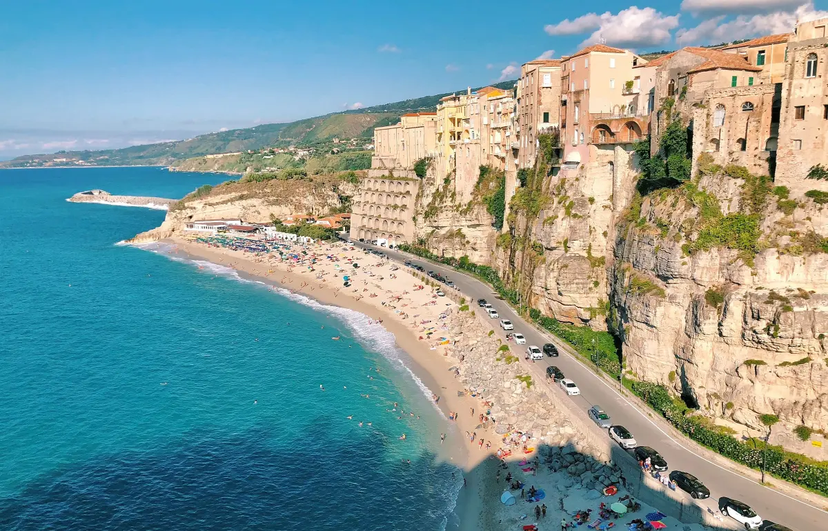 https://unsplash.com/photos/an-aerial-view-of-a-beach-with-a-cliff-in-the-background-Emjmmy2_uuo